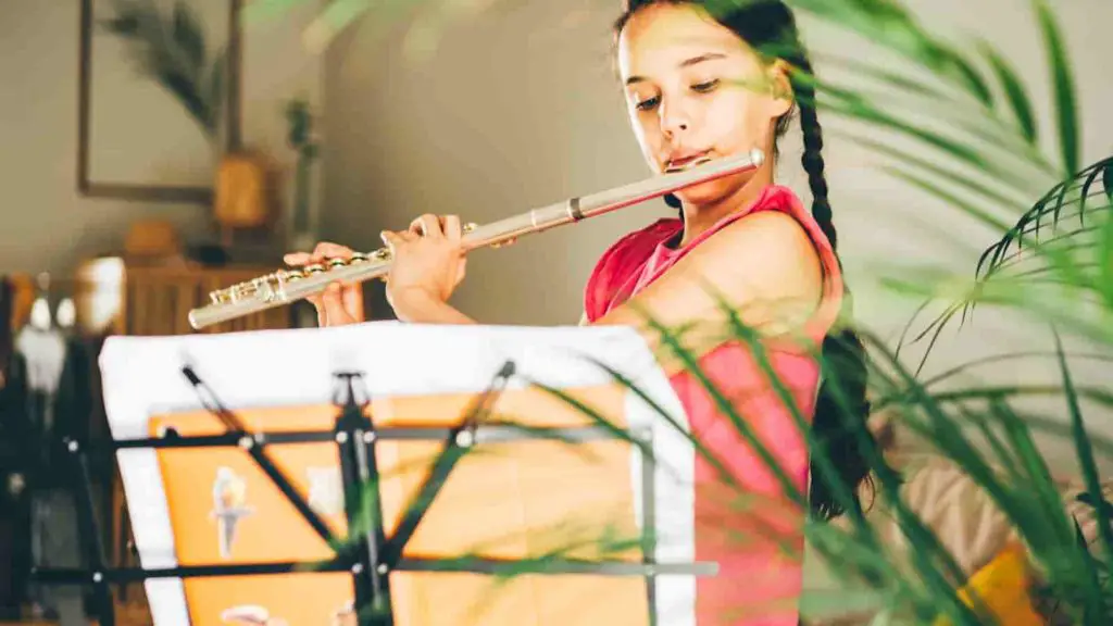 Girl playing the flute learning as a new student