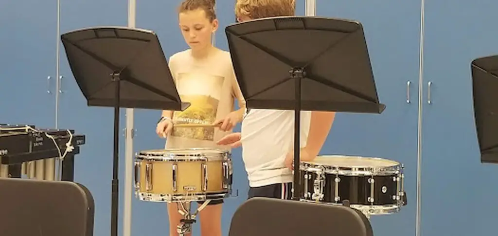 child learning to play the snare drum