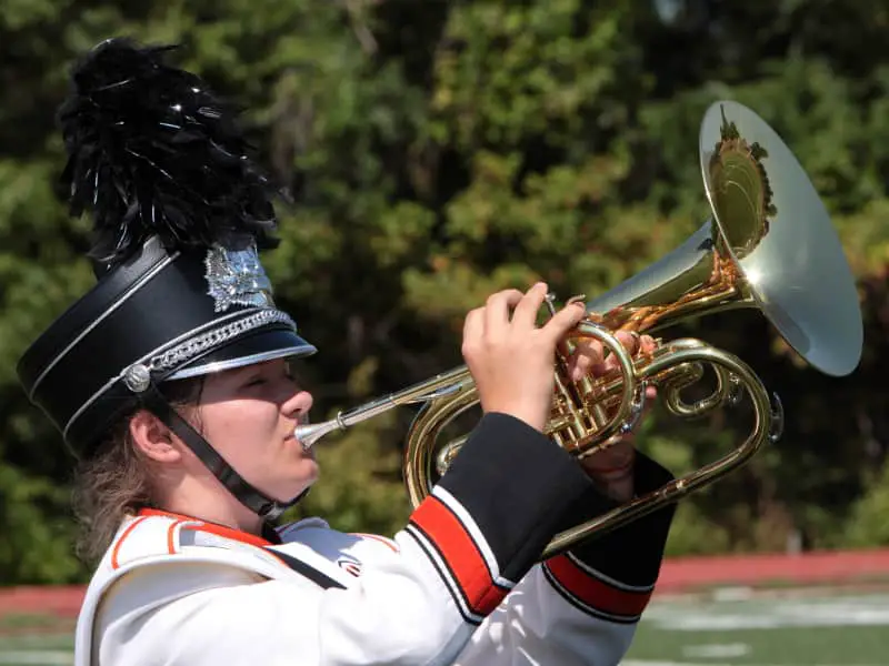 Woman playing the marching mellophone in the marching band
