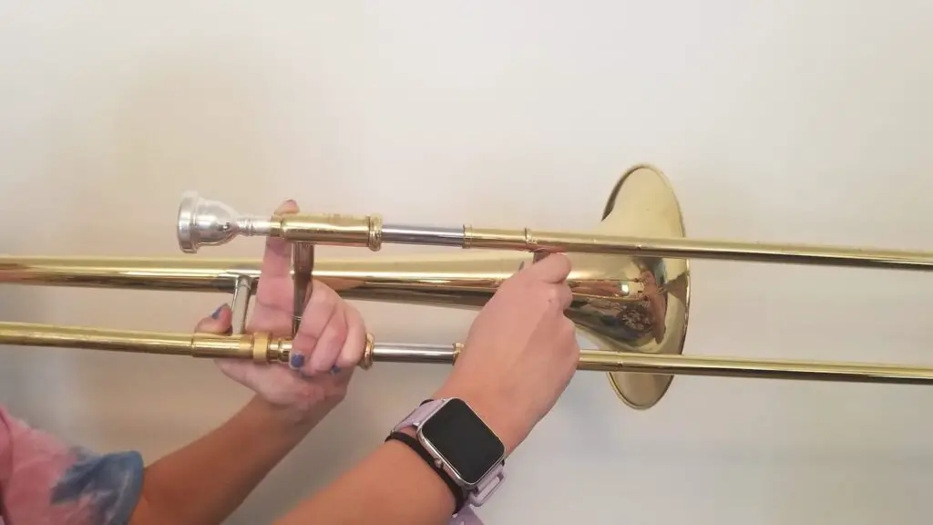 Holding a trombone in second position. 