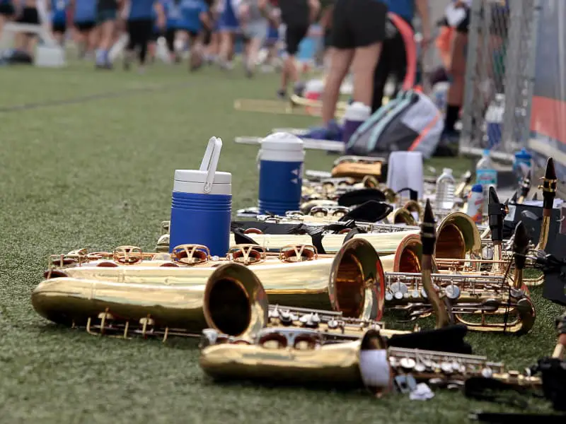 Heavy Baritone Saxophones laying down on the marching band field.