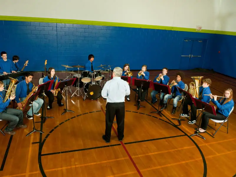 Middle school band practicing at band camp in the school gym