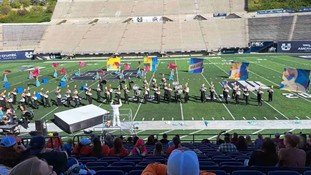 Marching band students standing on the field accepting their placement at a marching band competition