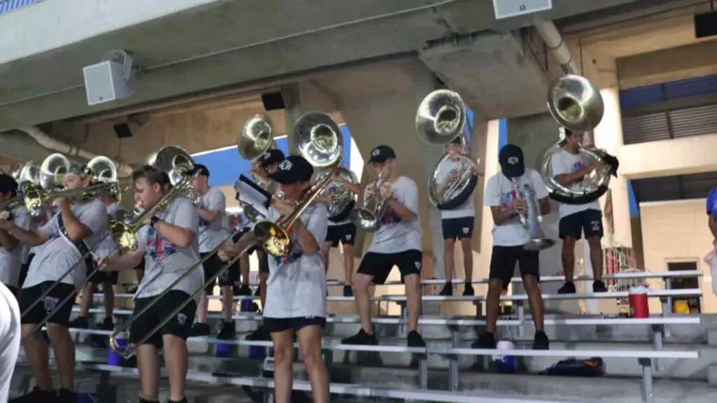 Band students playing stand tunes on the bleachers