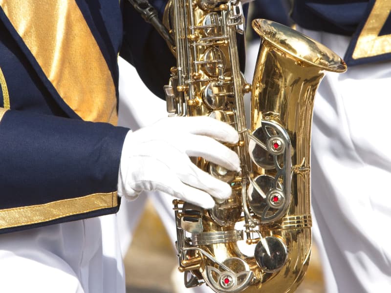 Marching band Saxophone player holding horn while performing