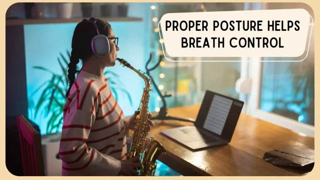saxophone player sitting up straight with headphones on playing sheet music from a laptop